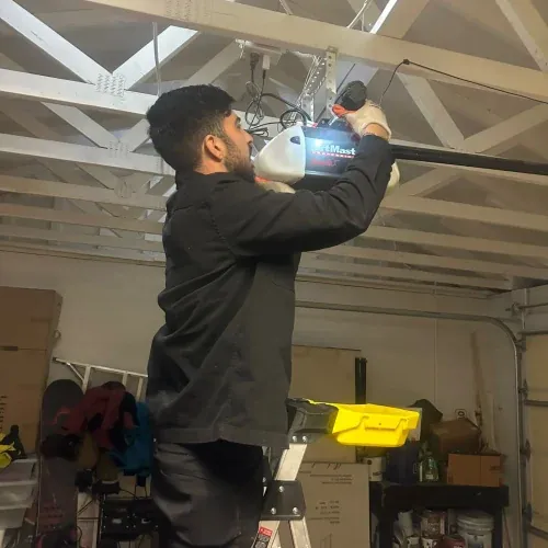 Ultimate Garage Door technician repairing a garage door opener